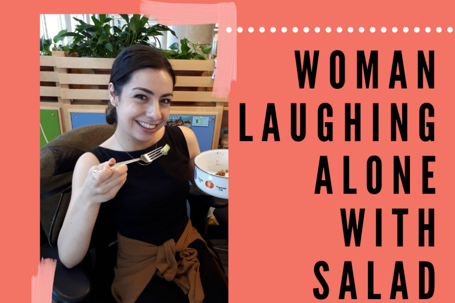 Woman laughing alone with salad