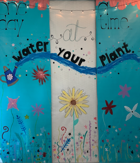 Blue artwork with the words "water your plant" written across it