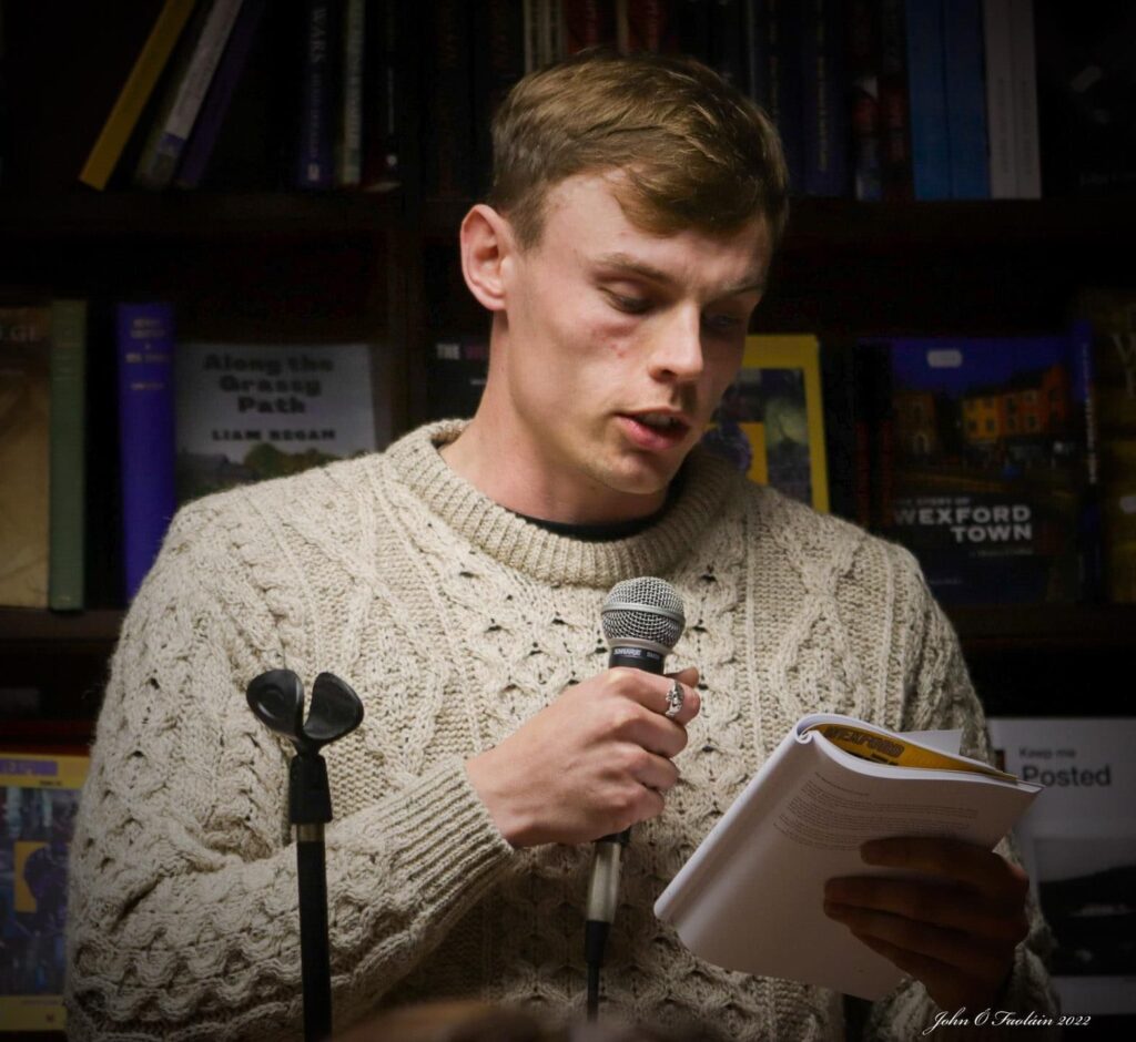White man reading from a book